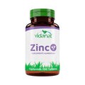 Frasco ámbar de 100 tabletas de Zinc Vidanat con tapa verde y etiqueta morada, sobre fondo blanco